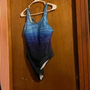 One piece swimsuit with a blue water pattern.